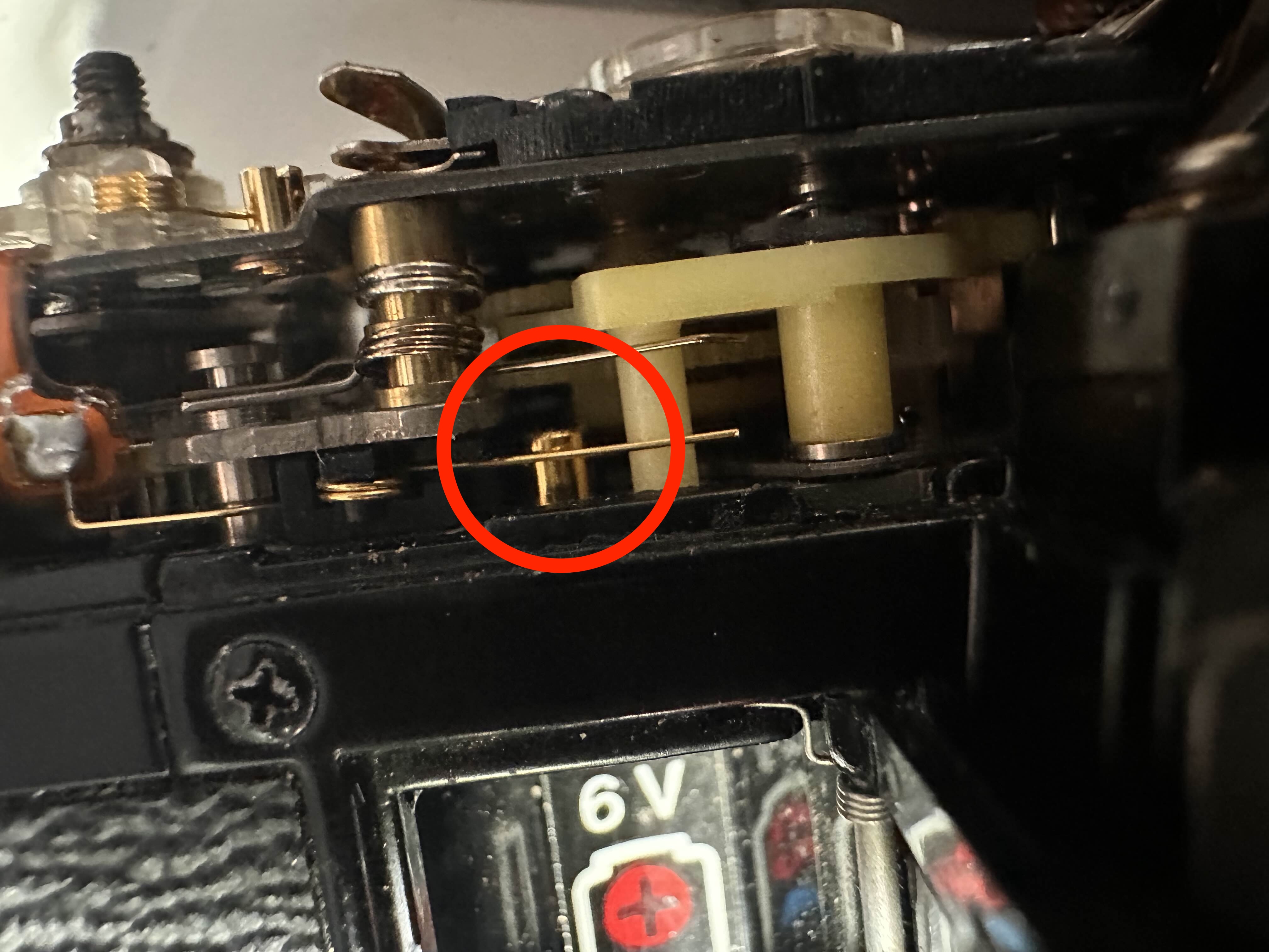 SW4 Contact under top plate, above battery compartment